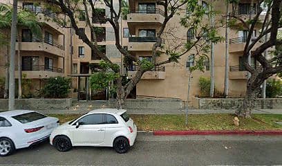Street-facing exterior of 8569 Burton Way; photo enhanced for presentation